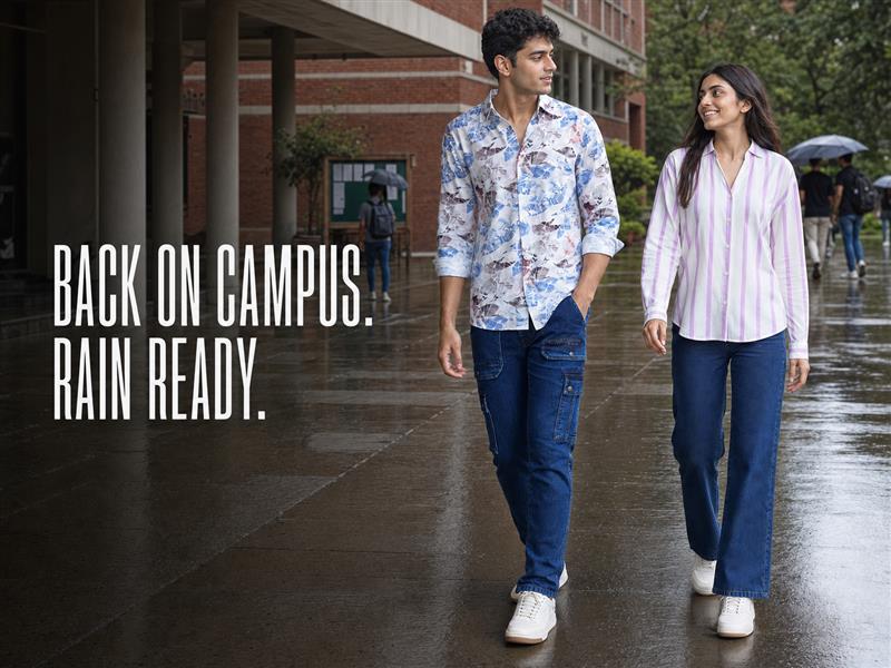 Man and woman wearing Spykar denim outfits on a rain-wet university campus | 