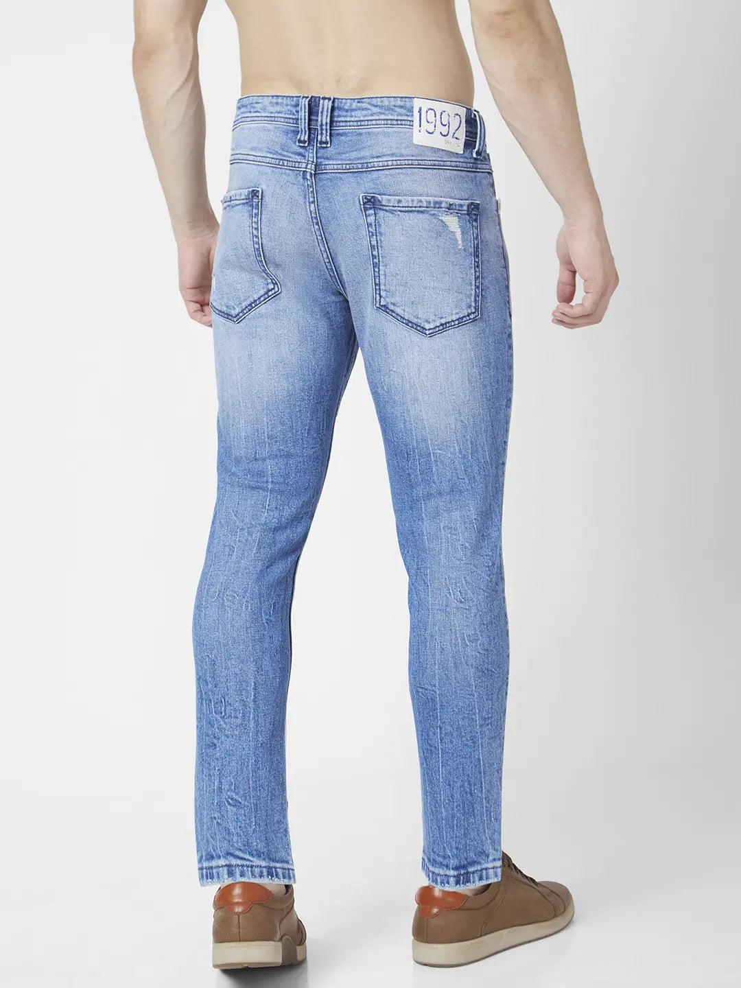 Spykar Men Light Blue Cotton Slim Fit Tapered Length Mild Distressed Mid Rise Jeans (Kano)